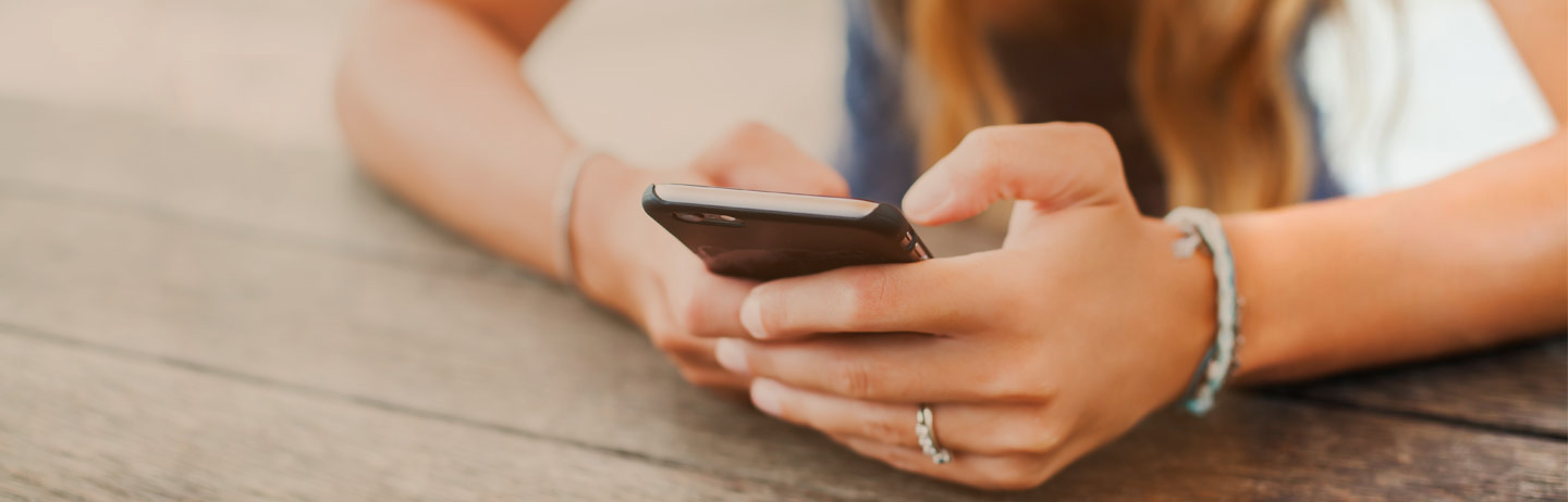 cropped photo of woman using a mobile phone
