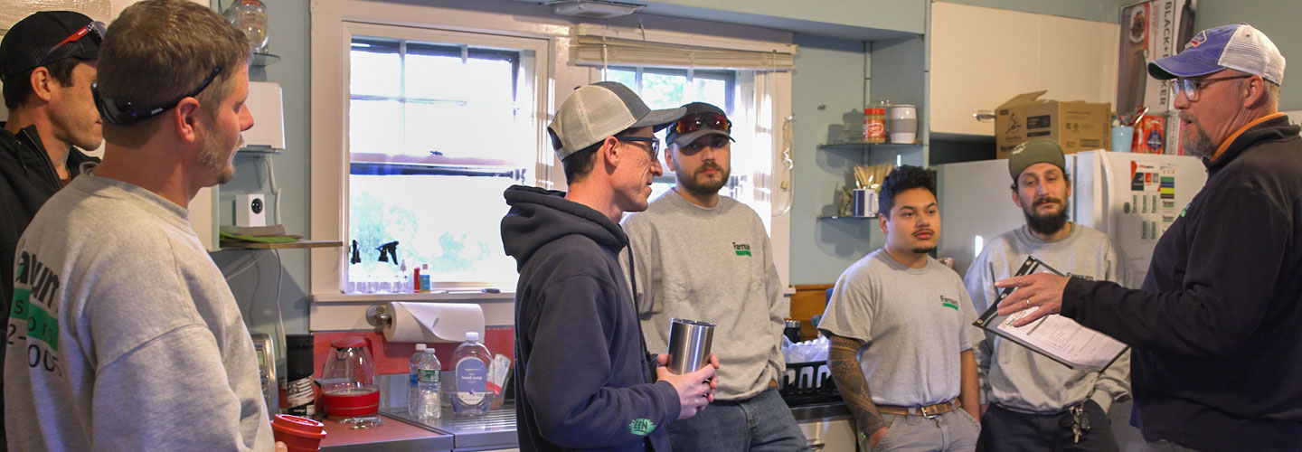 Photo of Farnum Insulators employees meeting in a break room