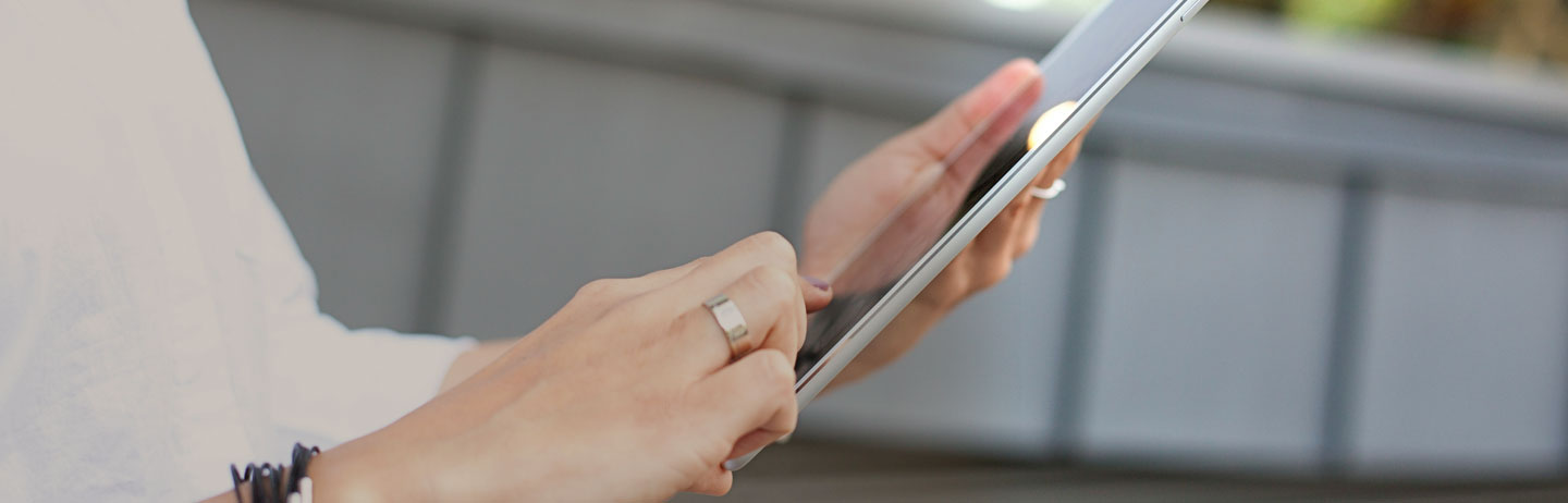 Close up photo of woman using a tablet