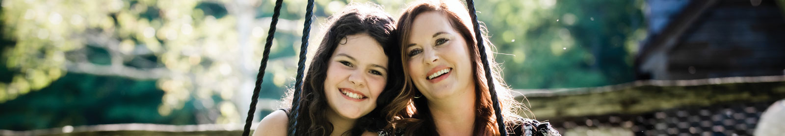 cropped photo of smiling mother and daughter